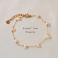 Detailed macro view of natural pearl bracelet with gold stainless steel chain and clasp - Starry Chain Bracelet