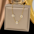 Elegant gold necklace featuring three small pearl daisy pendants on a fine beaded chain - Three Pearl Flower Necklace / Gold