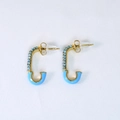 Close-up of J-shaped gold earrings with light blue rhinestones and enamel detail - Safety Pin Stud Earrings / Lake Blue