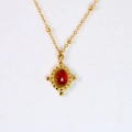 Detail of vintage gold necklace featuring a deep red agate pendant and beaded chain - Oval Pendant Style / Red Agate Pendant Necklace