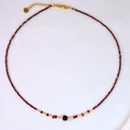 Detail of red faceted stone necklace with purple square bead and S.Steel tag - Center Square Bead Beaded Style