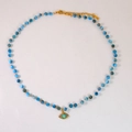 Detailed shot of Amazonite beaded necklace with golden 14K evil eye charm pendant - Evil Eye Blue Beaded Necklace (Necklace 2)