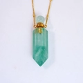 Close-up of light green hexagonal crystal perfume bottle pendant with a gold chain - Green Aventurine