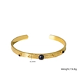 Brazalete abierto dorado de acero inoxidable con tres piedras negras facetadas - Ágata negra