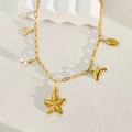 Close-up of 18k gold plated paperclip necklace with shell starfish dolphin pendants and pearl - Starfish
