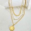 Detail of layered gold necklace with pearl accents and heart-textured coin pendant - Heart Style