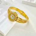 Detail of gold quartz bangle watch with rhinestone bezel and hollow Greek key pattern - Greek Key Style