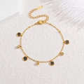 Close-up of gold stainless steel necklace with black round charms and zircon spheres - Black Bracelet