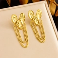 Detail of gold heart earrings with multilayer tassel chains on a beige display box - Heart Shape / Gold