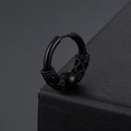Detailed close-up of matte black dragon pattern hoop earring in punk style finish - Black