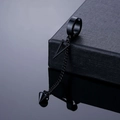 Detail of black punk hoop earring with chain, triangle, and spike pendant on leather - Black Triangle Dangle Ear Clip
