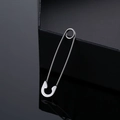Macro shot of silver stainless steel safety pin earring with high reflective finish - Steel