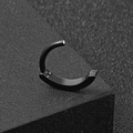 Detail shot of a matte black stainless steel hinged belly button ring on a textured surface - Black