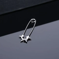 Silver stainless steel safety pin earrings with punk rivet accents on black surface - Steel