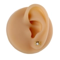 Detail view of a gold crab stud earring with white zircon inlay on a model ear - Gold Crab Style (B1392)