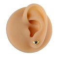 Macro detail of bat wing stud earring with black stone and gold finish on silicone ear model - Gold Bat Style (B1483)