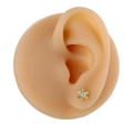 Macro shot of gold floral micro-pave cubic zirconia stud earring on an ear model - Flower Shape (B1372) / Gold