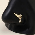 Golden star nose ring with crystal wing and teardrop charm on a nose model - Gold