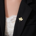 Elegant gold maple leaf brooch with detailed veins pinned on a black suit lapel - Gold Maple Leaf