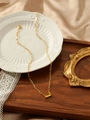 Macro view of gold paperclip chain necklace with rectangular orange zircon pendant - Yellow