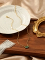 Detailed macro of gold paperclip chain and green rectangle zircon gemstone pendant - Light Green