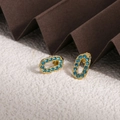 Boucles d'oreilles ovales dorées avec zircons bleus au design creux minimaliste - Zirconia Bleu (ZHE1981)