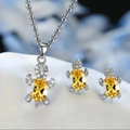 Macro view of turtle jewelry set with yellow gemstone and sparkling white crystals - Yellow