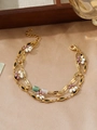 Detailed macro view of gold-layered anklet featuring green stones and daisy charms - Black Enamel Daisy Triple-layer Style (ZHB885金)