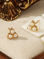 Detail view of triple pearl earrings with gold base on a textured fabric background - Three-Artificial Pearl Cluster Style (ZHE326白)