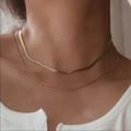 Detail of layered gold herringbone and snake chain necklaces worn on a model neckline - Thick And Thin Double Layer Snake Chain (ZHN1110金) / 18K Gold