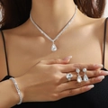 Silver bridal jewelry set with sparkling teardrop crystals on an elegant model - Silver Water Drop Round Diamond Necklace Bracelet Ring Earrings Set (PJ--T0297)