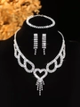 Close-up of silver bridal jewelry set with sparkling rhinestones and heart tassel detail - Silver Hollow Heart Tassel Necklace Bracelet Earrings Set (PJ--T0213)