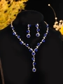 Macro view of blue zircon necklace set with cascading teardrop earrings on velvet stand - Golden Blue Luxury Neck Jewelry Set (PJ--T0033-3)