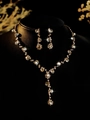 Detailed view of bridal jewelry set with sparkling pear-cut crystals on black background - Golden White Necklace and Earring Set (PJ--T0038)
