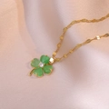 Elegant gold titanium necklace with green clover pendant and zircon on satin fabric - Green