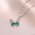 Detail of silver butterfly pendant with green pear-cut stones and white zircon crystals - Emerald Butterfly Necklace / Steel