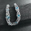 Detail of silver chain bracelet with blue beads on a black textured display - Sky Blue