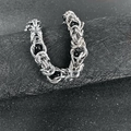 Macro shot of silver woven titanium steel chain with black beads for men - Black