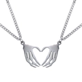 Detail of gothic stainless steel necklace set with skeleton hands forming a heart shape - Silver Heart Splicing Pair Necklace / Silver Pair Set