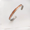 Close-up of titanium steel cuff bangle with red base and golden dragon pattern engraving - Steel Orange Light Dragon