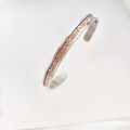 Detail of a Celtic dragon pattern open bangle with rose gold and silver finish - Steel Non-Luminous Dragon
