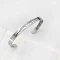 Macro view of silver cuff bracelet with detailed feather engraving and open design - Vintage Leaf Vein Silver Style