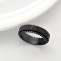 Close-up of black moon and star embossed spinning ring with gear edges for anxiety relief - US 6 / Black