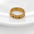 Detail of gold star and moon rotating anxiety ring with gear edges on white ceramic - US 6 / Gold
