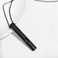 Detail of a functional black titanium steel whistle pendant necklace on white background - Black