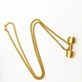 Golden dumbbell pendant necklace for gym lovers on a minimalist white background - Gold