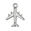 Macro shot of a vintage silver-tone metal airplane pendant with a polished mirror finish - Steel