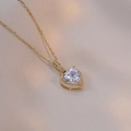 Macro shot of gold heart pendant necklace featuring large zircon and halo diamond setting - White Heart Style / White