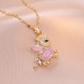 Golden rabbit pendant necklace with pink zircon crystals on soft silk background - Titanium Steel / Pink Zirconia Rabbit