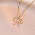 Elegant gold bow necklace with cubic zirconia pendant on luxury silk background - Gold